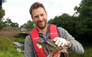 An ecologist holding a terrapin