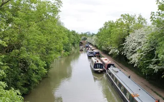 Moored boats double breast along a busy stretch of the Leicester Line Grand Union