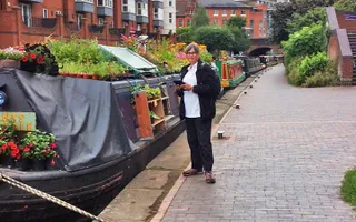 Canal & River Trust worker checks narrowboat licences in Birmingham