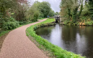 wide shot of a towpath and canal with locks in the distance