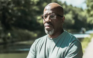 Canal laureate, Roy McFarlane standing next to the canal