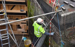 A man repairing part of the canal