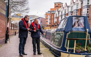 Two men checking boat licences