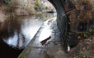 Old canal cobbled towpath under a bridge