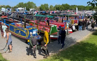 Wide shot a marina filled with colourful narrowboats