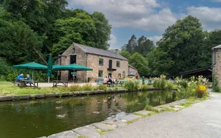 Spring scene, cafe in the distance, next to the canal. Cloudy day, but full of the colours of spring.