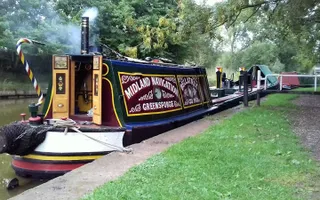 Narrowboat with lit stove in back cabin