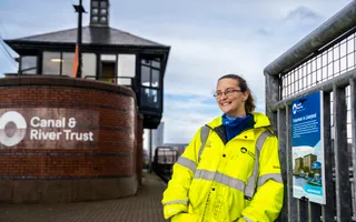 Volunteer standing in front of Canal & River Trust office along Leeds & Liverpool Canal