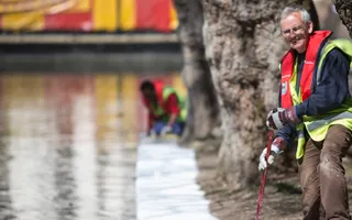 Volunteers work by the canal