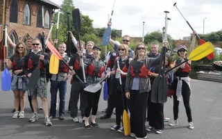 A group of paddlers getting ready to get in their canoes