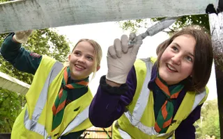 Two Scouts paint a lock gate in Stoke Bruerne