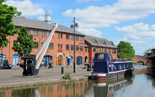 Coventry Canal, with a narrowboat and canalside buildings